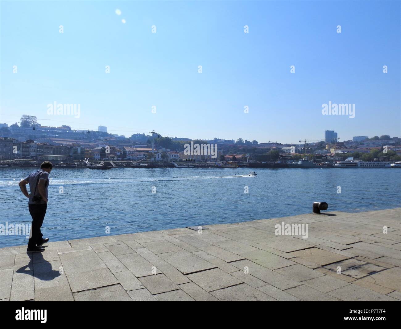 Un pensieroso uomo cammina lungo il fiume Duero. Porto. Il Portogallo. Foto Stock