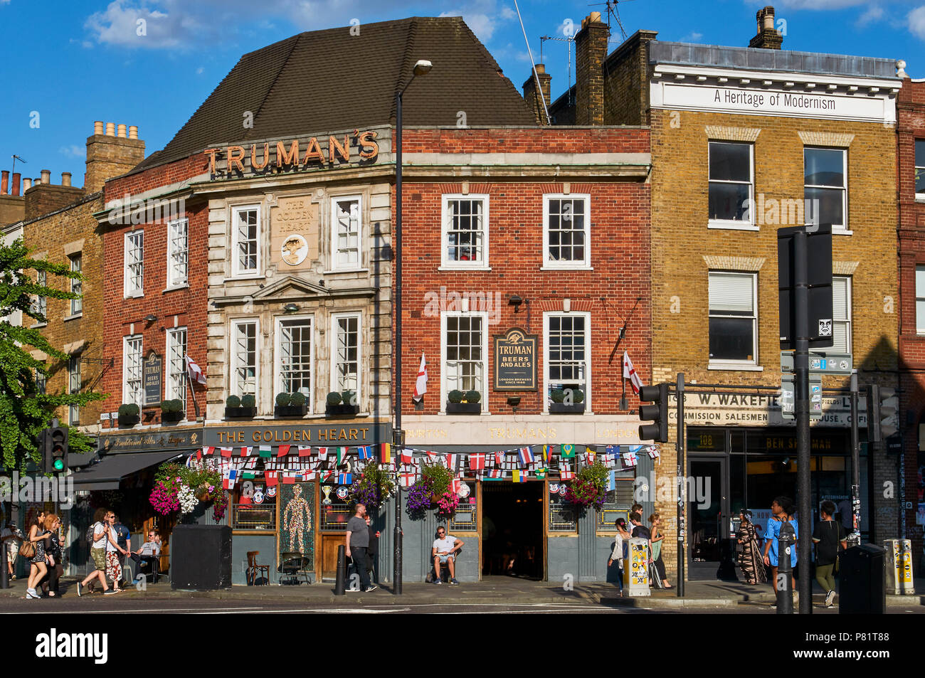 Il cuore d'oro public house in Spitalfields, East London UK, con pedoni e bandiere per celebrare il 2018 World Cup Foto Stock