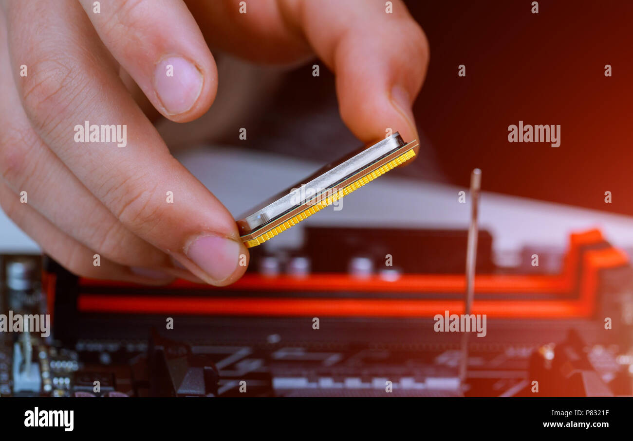 Il tecnico Installazione del moderno processore nel socket della CPU sulla scheda madre Foto Stock