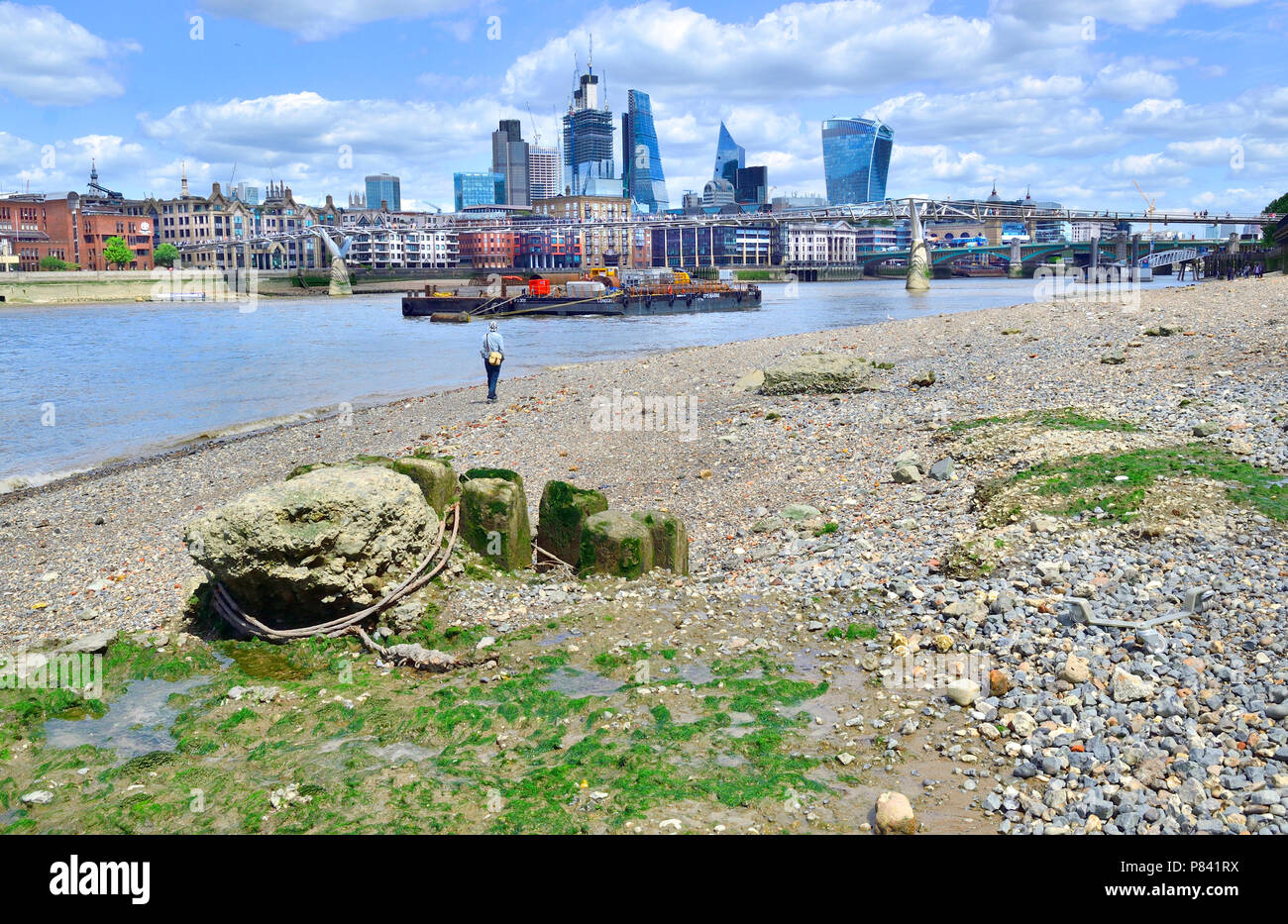 Il fiume Tamigi con la bassa marea. Londra, Inghilterra, Regno Unito. South Bank beach e la City of London skyline Foto Stock