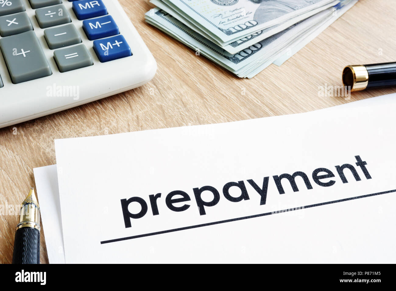 Modalità di pagamento anticipato. Documento, calcolatrice e di dollari su una scrivania. Foto Stock