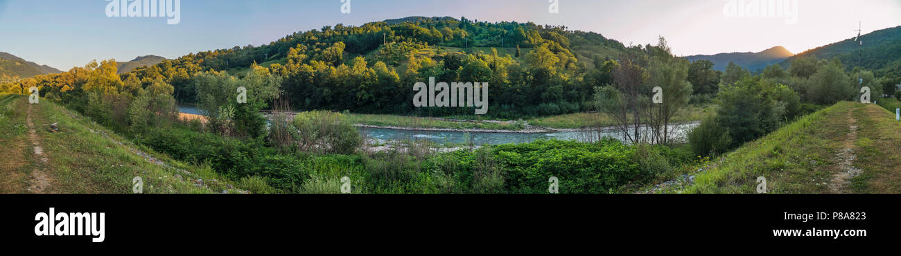 Un panorama di alta diga vicino a un tempestoso fiume di montagna ai piedi della collina sotto il celeste . Per il vostro design Foto Stock