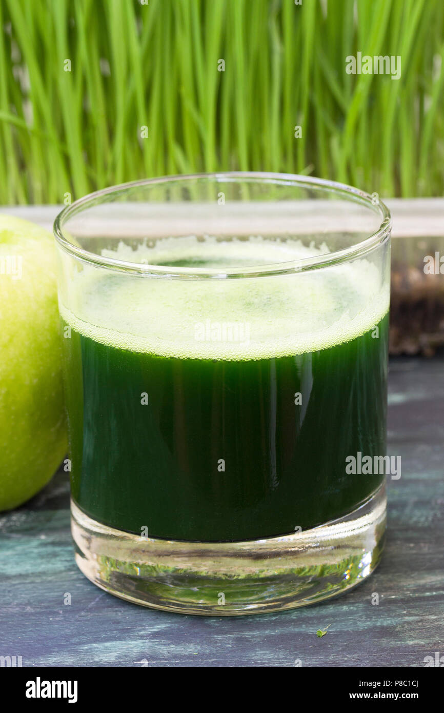 Bicchiere di spremuta fresca da erba di frumento e mela verde Foto Stock