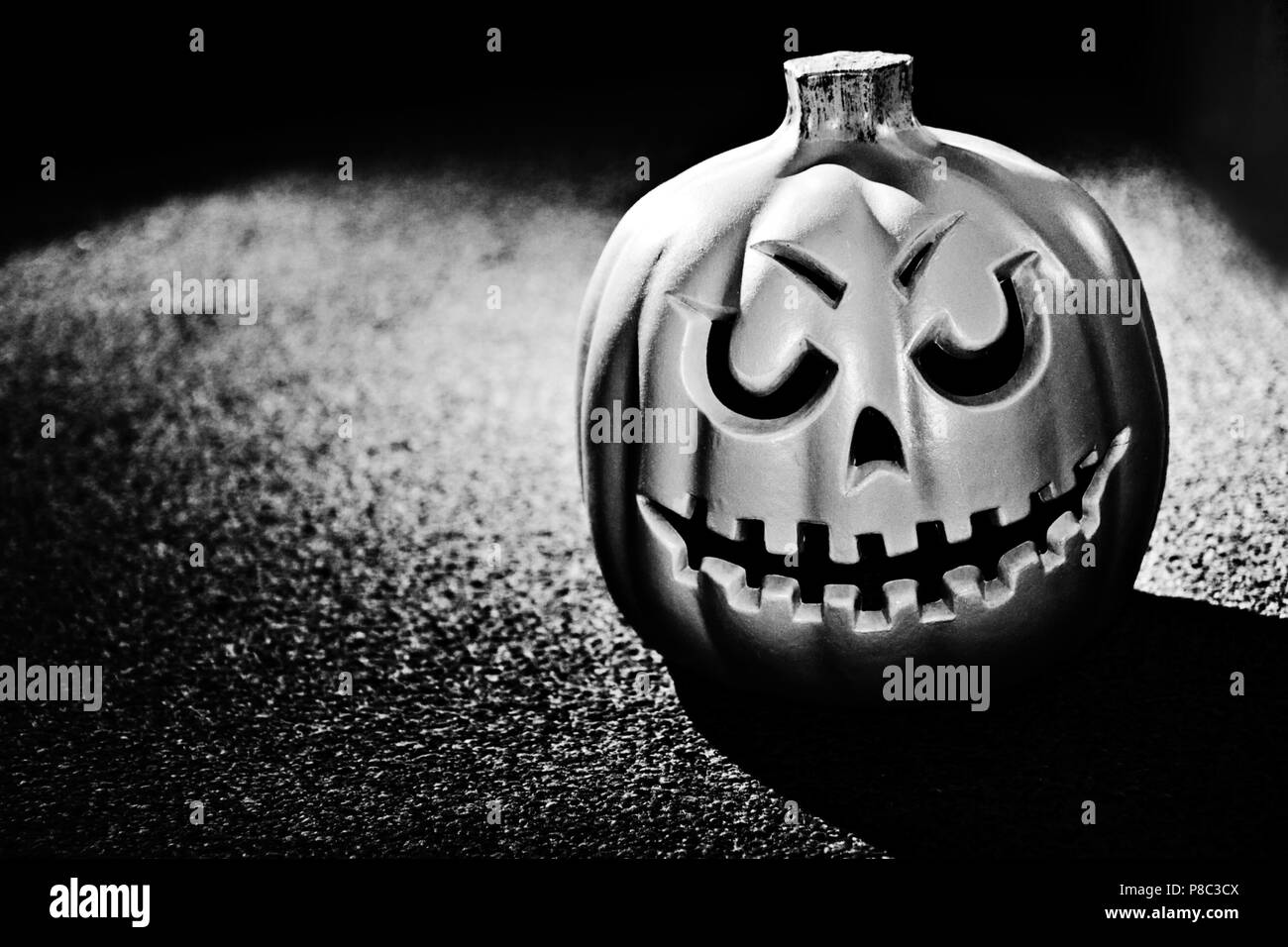 Pumpking singolo contro una trama pesantemente lo sfondo in bianco e nero Foto Stock