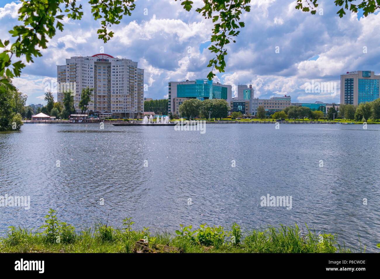 Un panorama di un laghetto con fontane e la sponda opposta con nuovi edifici ad alta . Per il vostro design Foto Stock