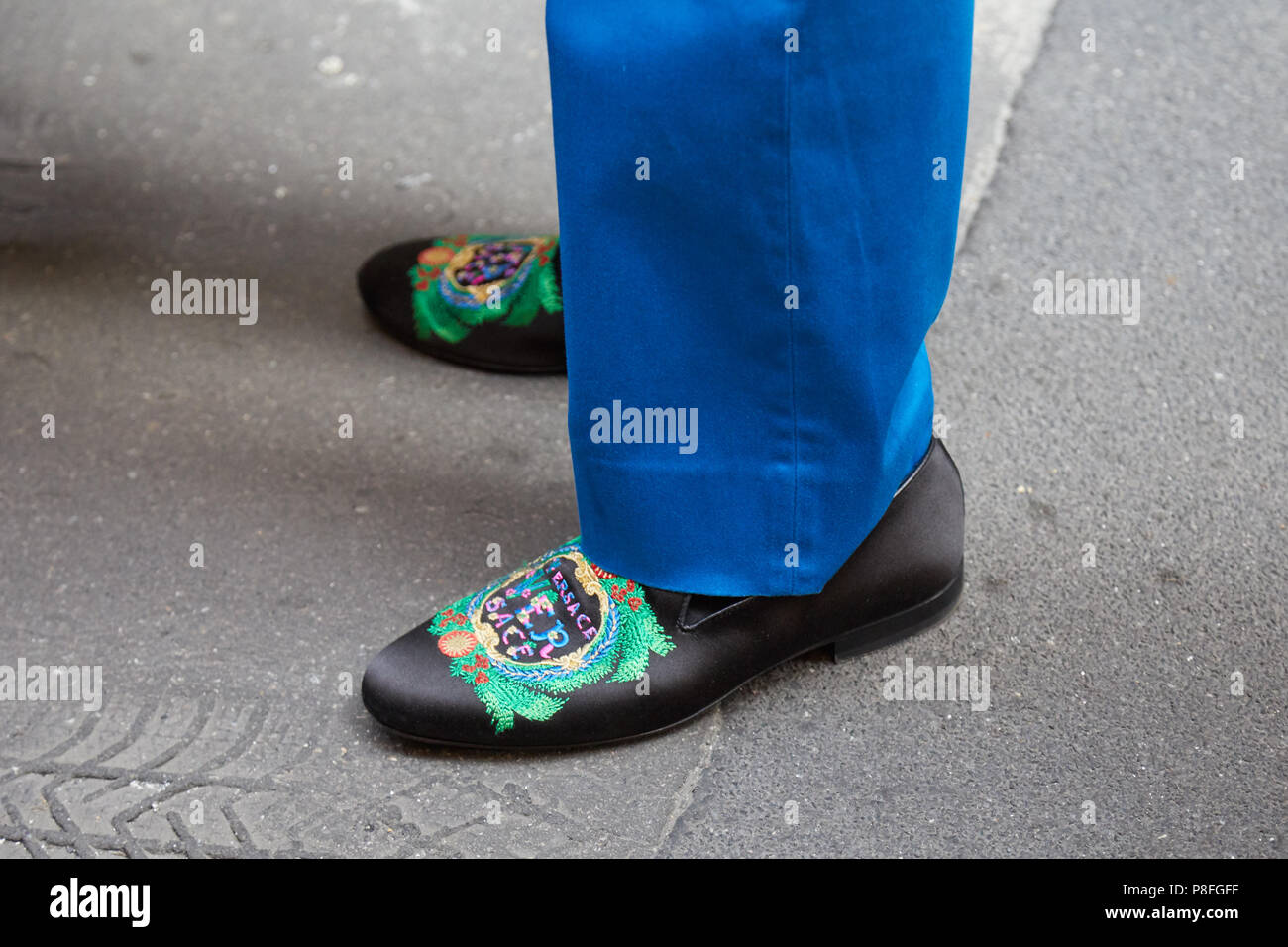 Milano - 16 giugno: l uomo con il nero Versace scarpe con decorazione verde  e pantaloni blu prima di Versace fashion show, la Settimana della Moda  Milanese street style Foto stock - Alamy