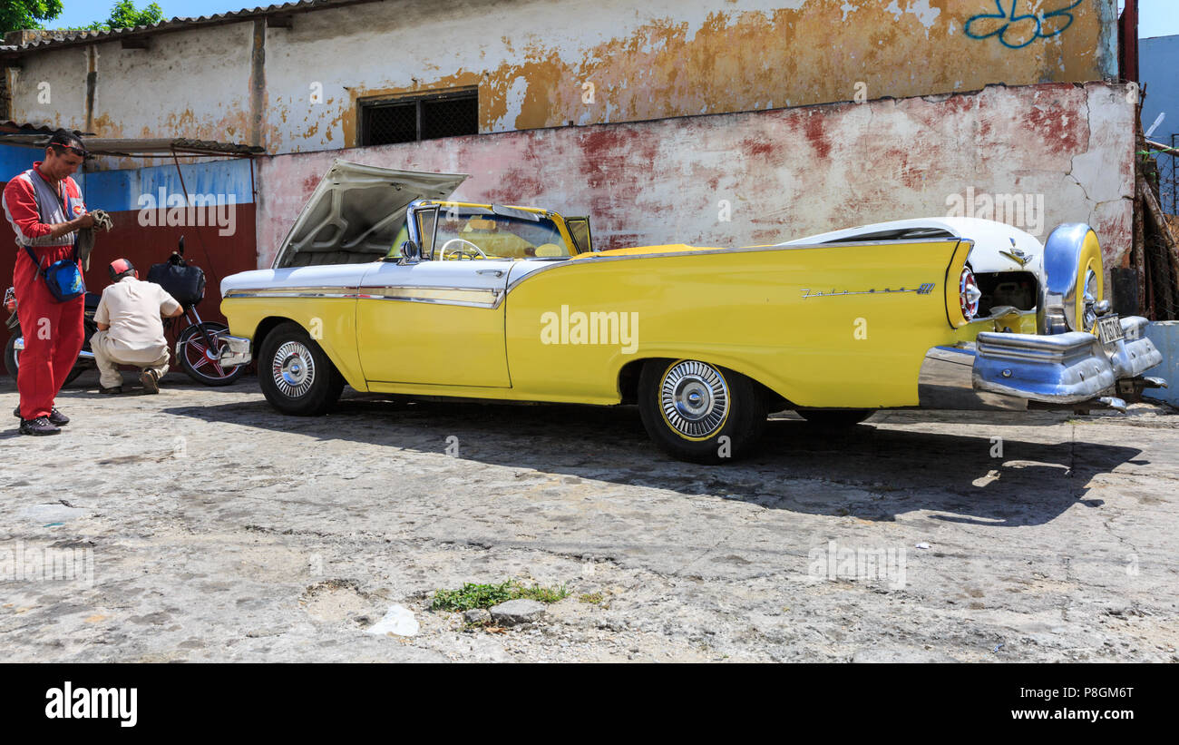 1957 Ford Fairlane 500 Skyliner convertibile in giallo, American classic car essendo pulito presso un garage a l'Avana, Cuba Foto Stock