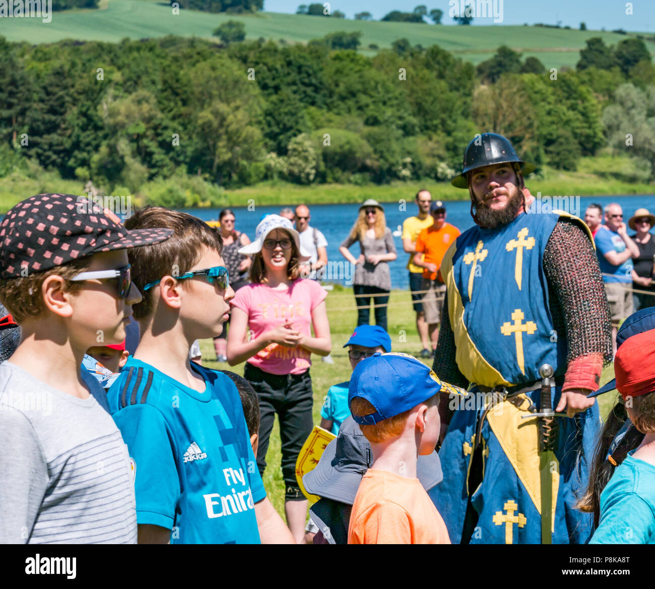 Fiera medievale, Linlithgow Palace, Scotland, Regno Unito. Estate entertainment famiglia giornata di divertimento con la storica società si intraversa membri vestito in costume militare Foto Stock