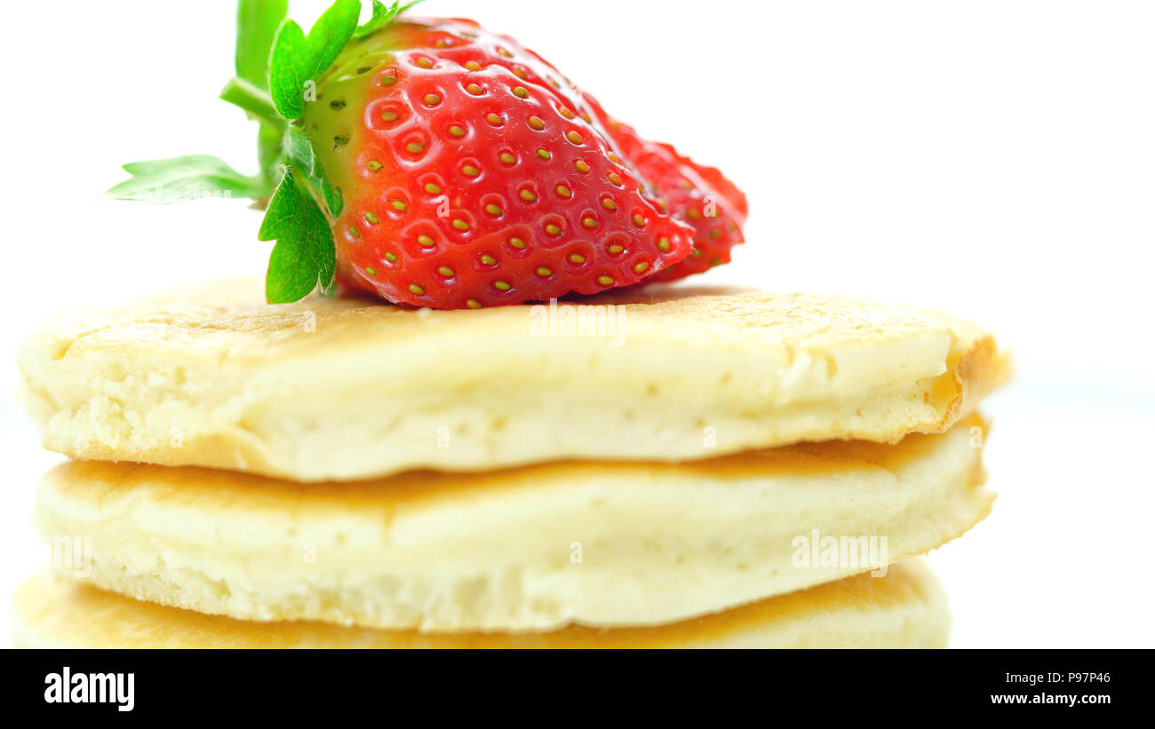 Pila di pancake con fragole in cima, macro closeup. Foto Stock