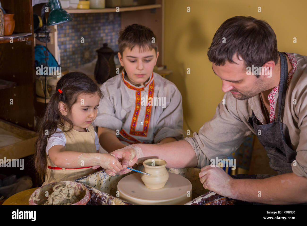 Potter che mostra come lavorare con ceramica in ceramica studio Foto Stock
