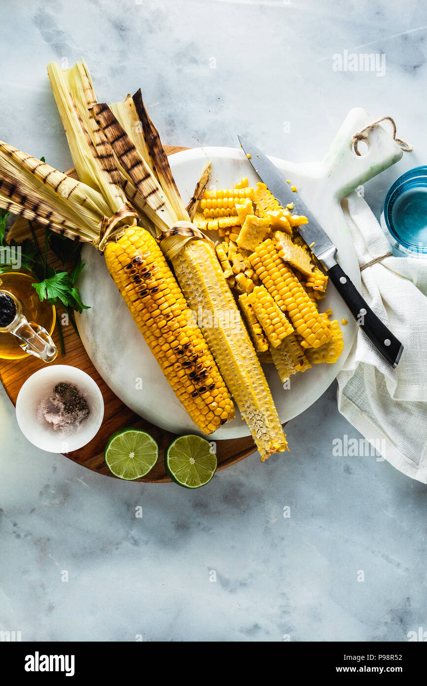 Tagliare il mais dalla pannocchia. Cucina estate un pasto leggero. insalata o luce pranzo sano Foto Stock