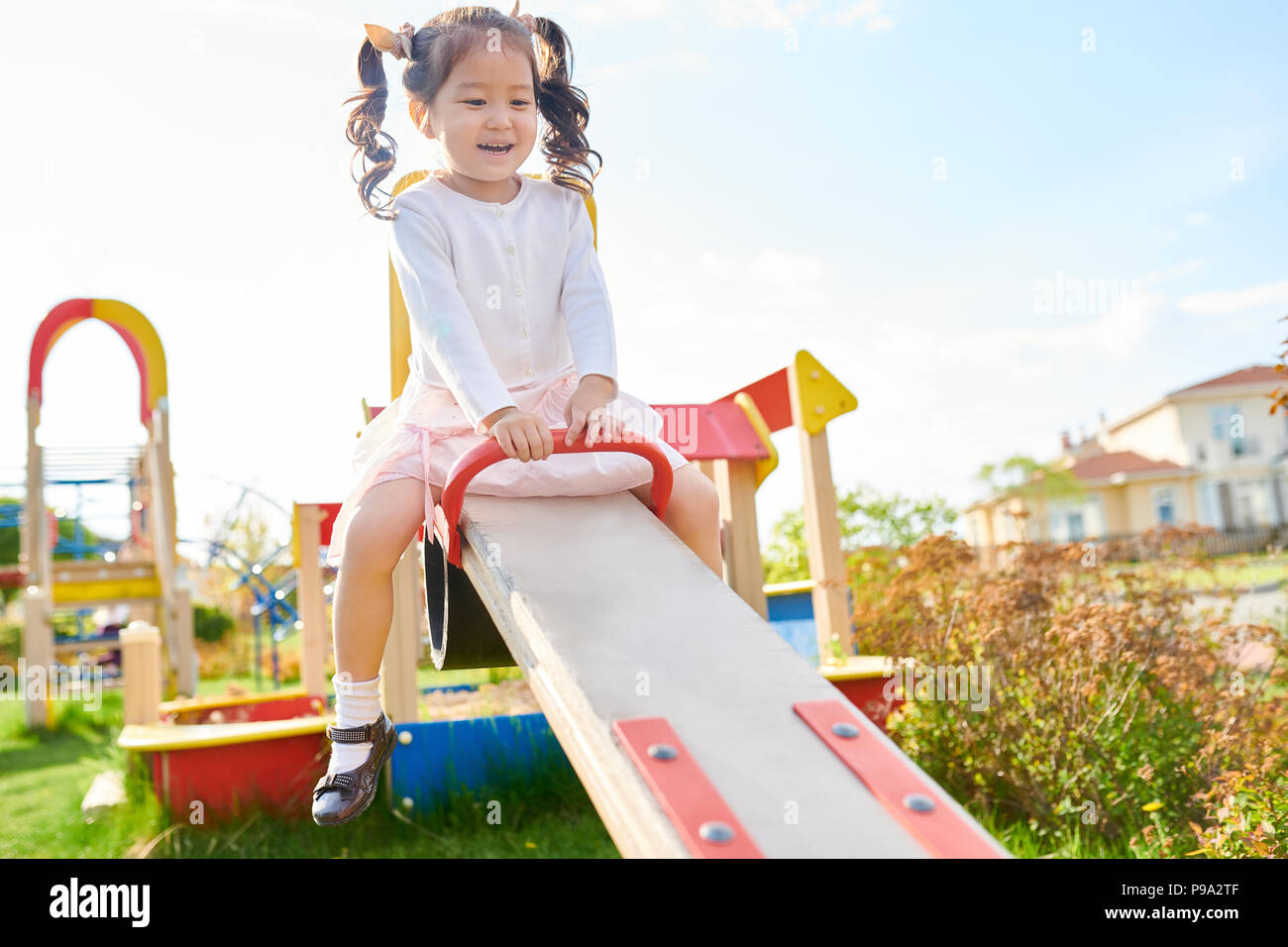 Carino ragazza asiatica sul parco giochi Foto Stock