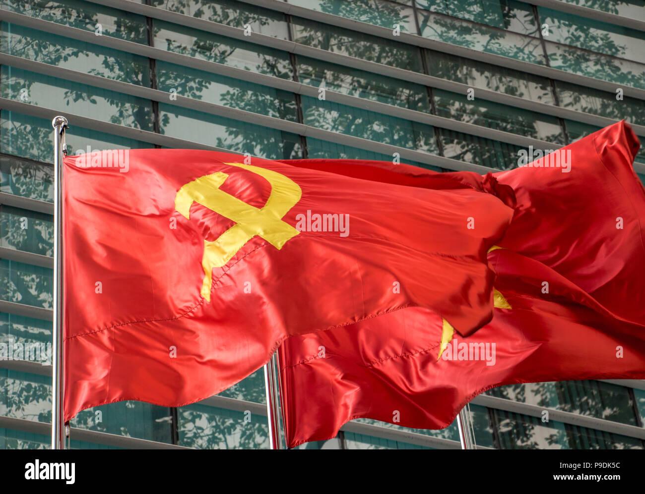 La bandiera rossa con i simboli comunisti di una falce e martello che vola  da costruire.La bandiera rossa con una stella a cinque punte sventola sul  palo Foto stock - Alamy