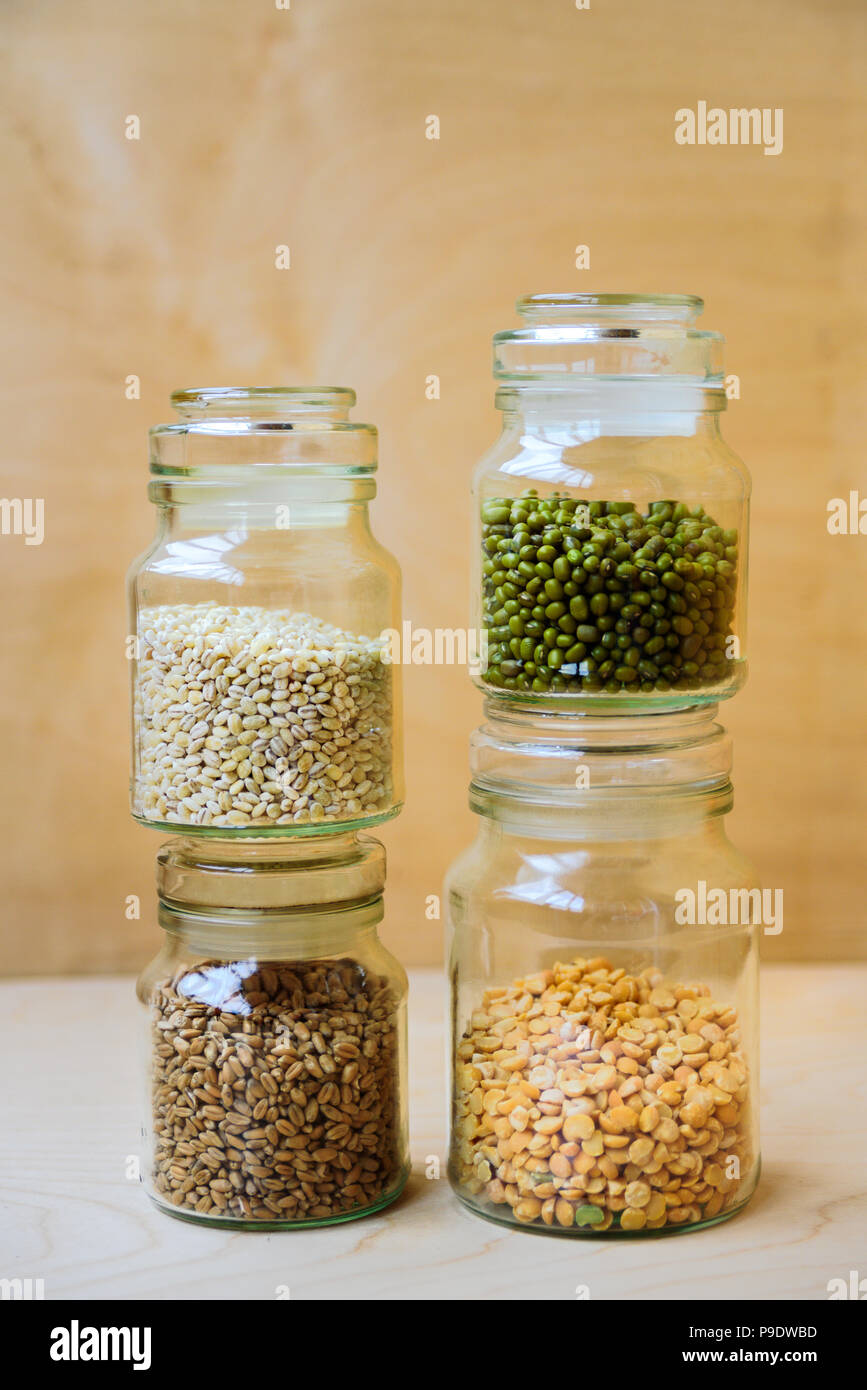 Mung bean in un barattolo di vetro nei pressi di piselli secchi, di riso e di orzo perlato Foto Stock