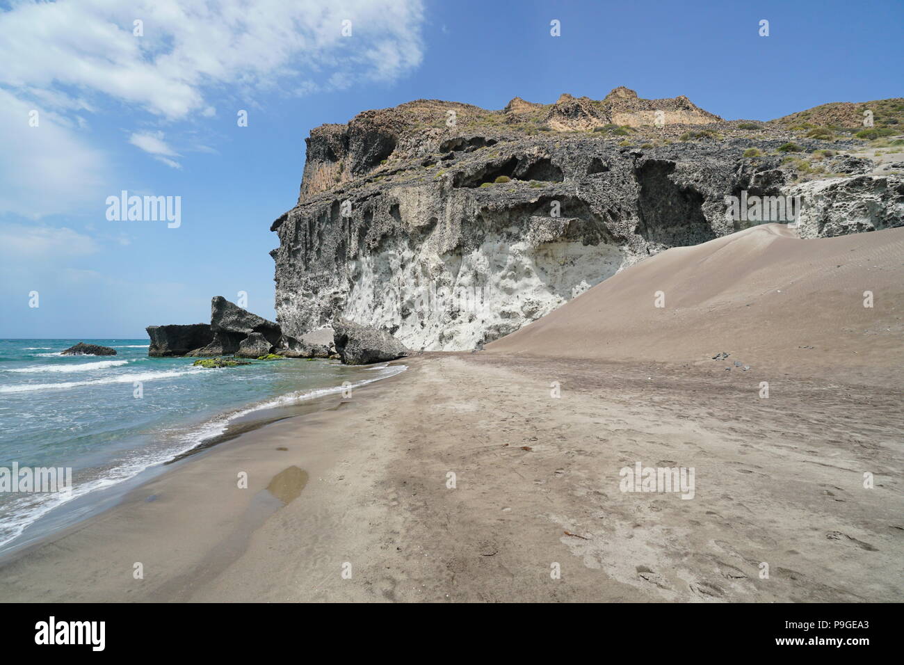 Spiaggia di sabbia e la scogliera di roccia, Cala Chica in Cabo de Gata-Níjar parco naturale, mare Mediterraneo, Almeria, Andalusia, Spagna Foto Stock
