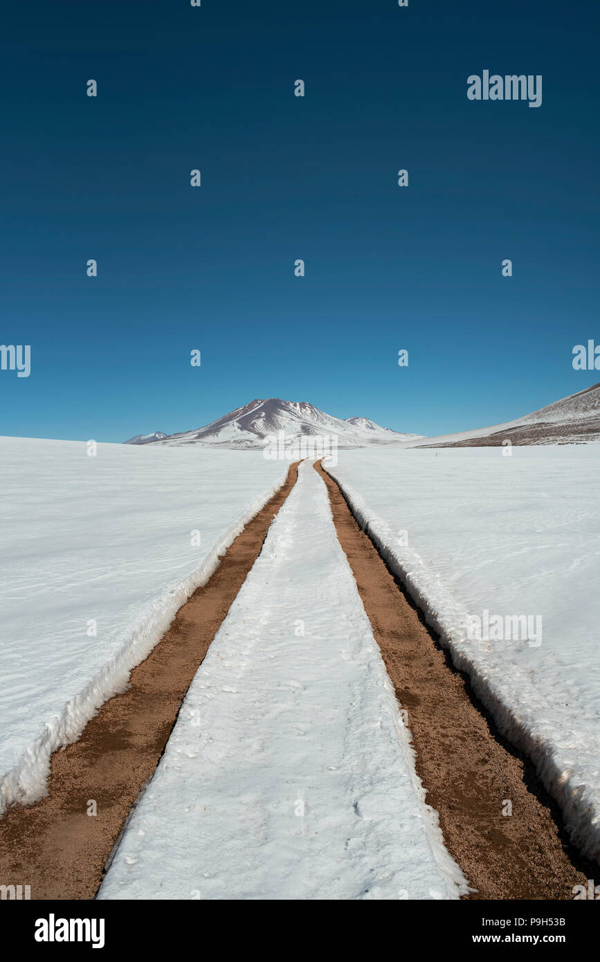 Paesaggio Wintery e coperta di neve strada con auto brani di Eduardo Avaroa fauna Andina riserva nazionale, Bolivia, Sud America. Giu 2018 Foto Stock
