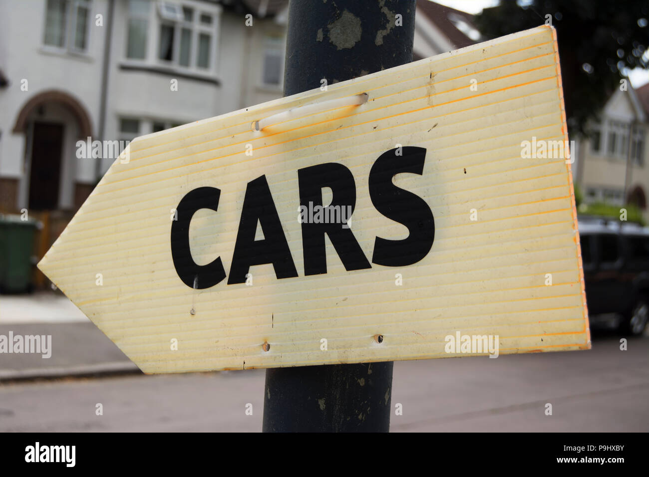 Segno di freccia indicante le vetture, in east twickenham, midlsex, Inghilterra, presumibilmente indicando le direzioni ad un rivenditore di auto Foto Stock