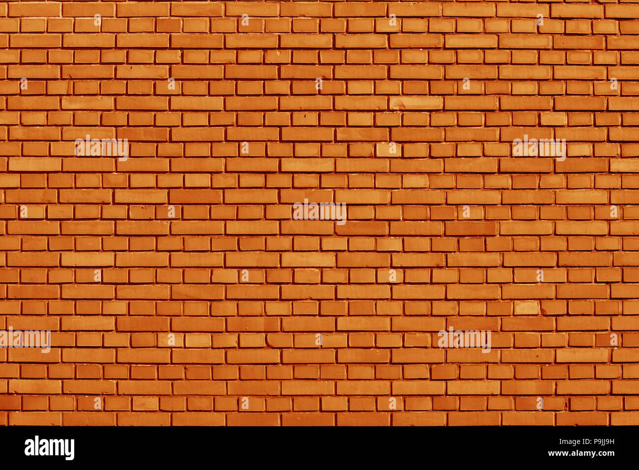 Russet color arancione muro di mattoni in background Foto Stock