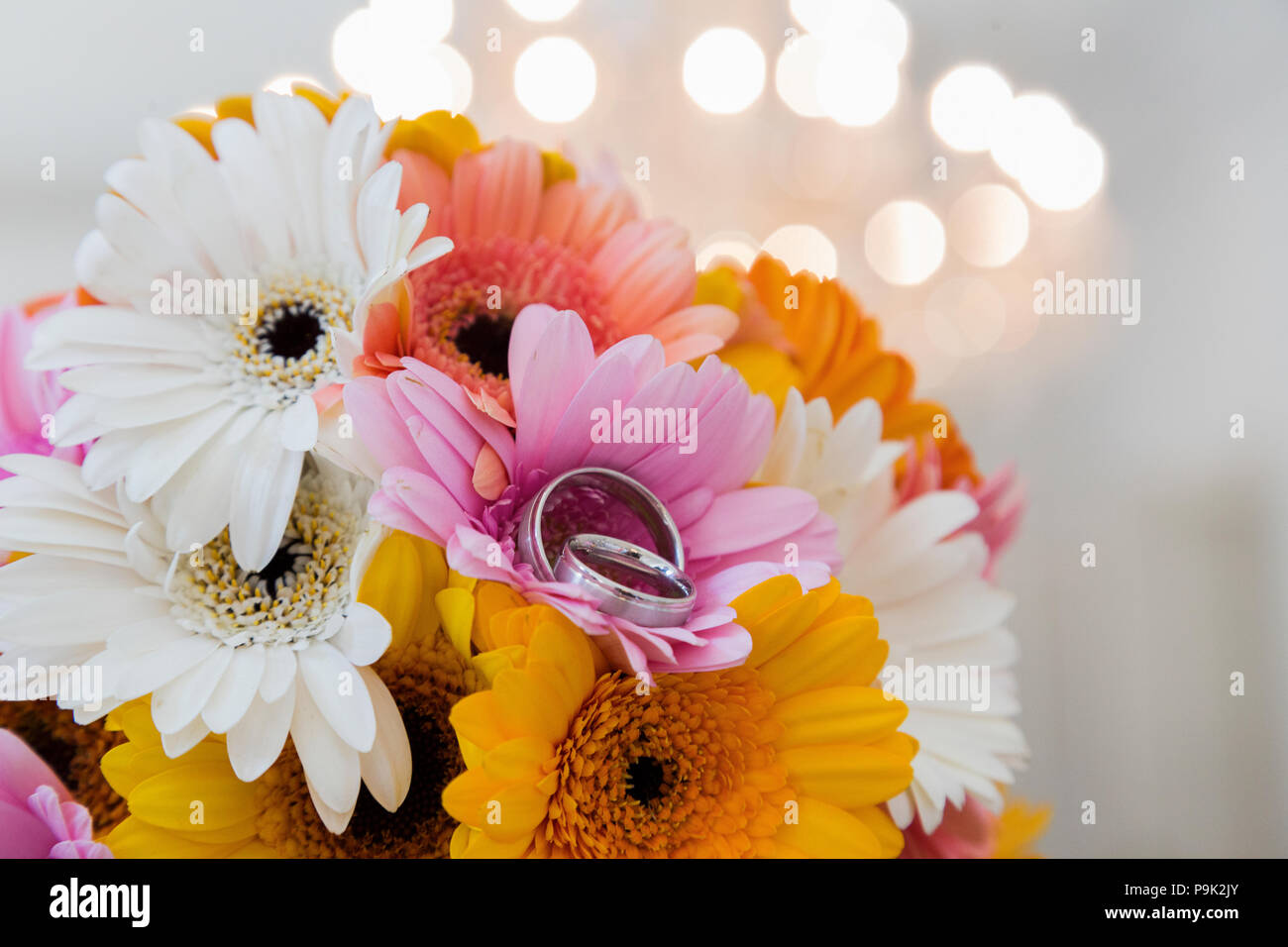 Bouquet di crisantemi e gli anelli giacente su marmo Foto Stock