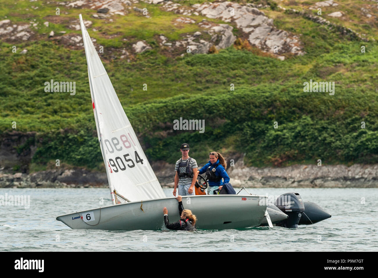 Schull, West Cork, Irlanda. 19 Luglio, 2018. I giovani provengono da tutta l'isola di Irlanda, incluso il Nord, per prendere parte alla regata delle scuole che si rivolge al debuttante marinai corse. Uno dei marinai capsizes suo dinghy. Credito: Andy Gibson/Alamy Live News. Foto Stock