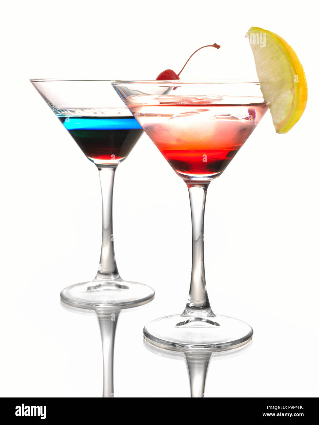 Due cocktail Martini con una ciliegia su uno sfondo bianco Foto Stock