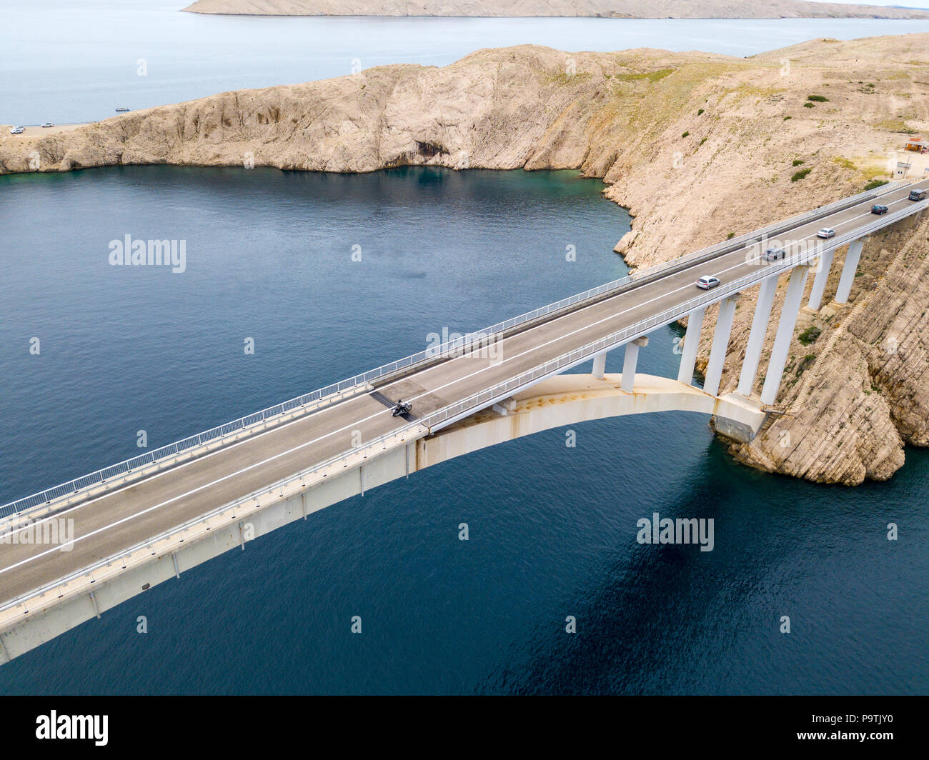 Vista aerea del ponte dell'isola di Pag, Croazia, su strada. Scogliera affacciato sul mare. Vetture attraversando il ponte visto da sopra Foto Stock