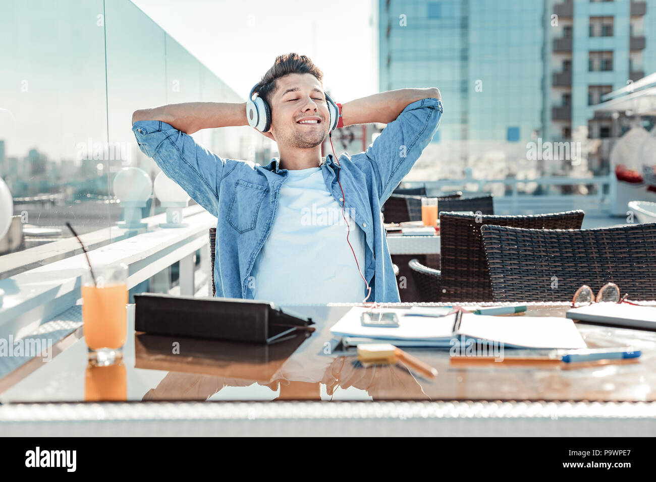 Rilassata persona di sesso maschile in ascolto musica Foto Stock