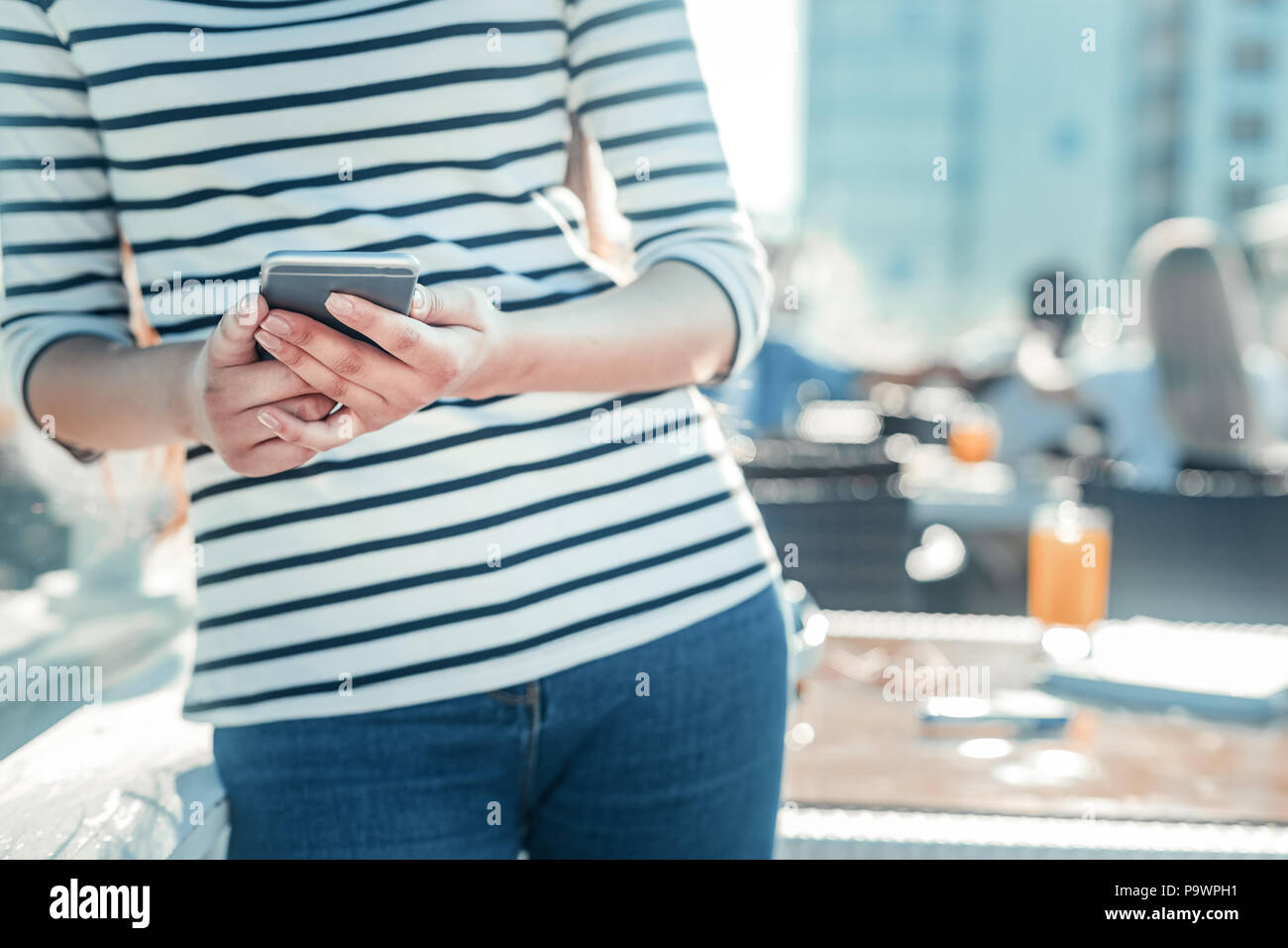 Close up di mani femminili che lo smartphone di contenimento Foto Stock