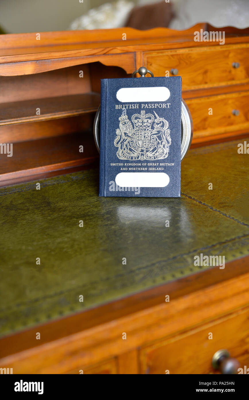 Antica scrivania con passaporto e il vecchio orologio sveglia con nomi tranciati Foto Stock