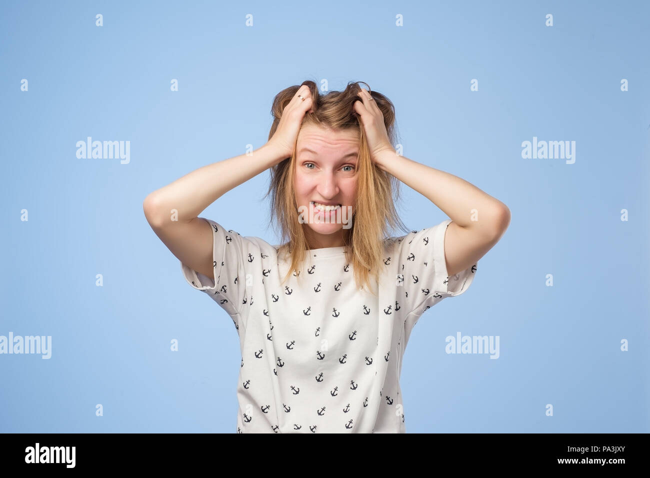 Ritratto di un frustrato arrabbiato donna urlando a voce alta e tirando i suoi capelli fuori Foto Stock
