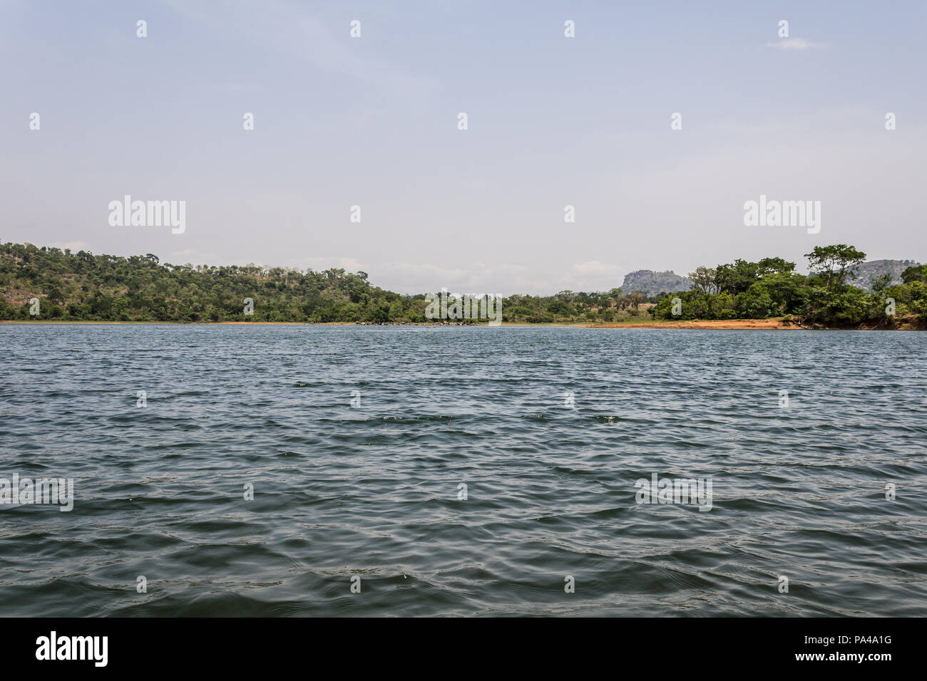 Una bella e pittoresca vista delle montagne, cielo, verde e lussureggiante foresta pluviale e grande corpo di acqua Foto Stock