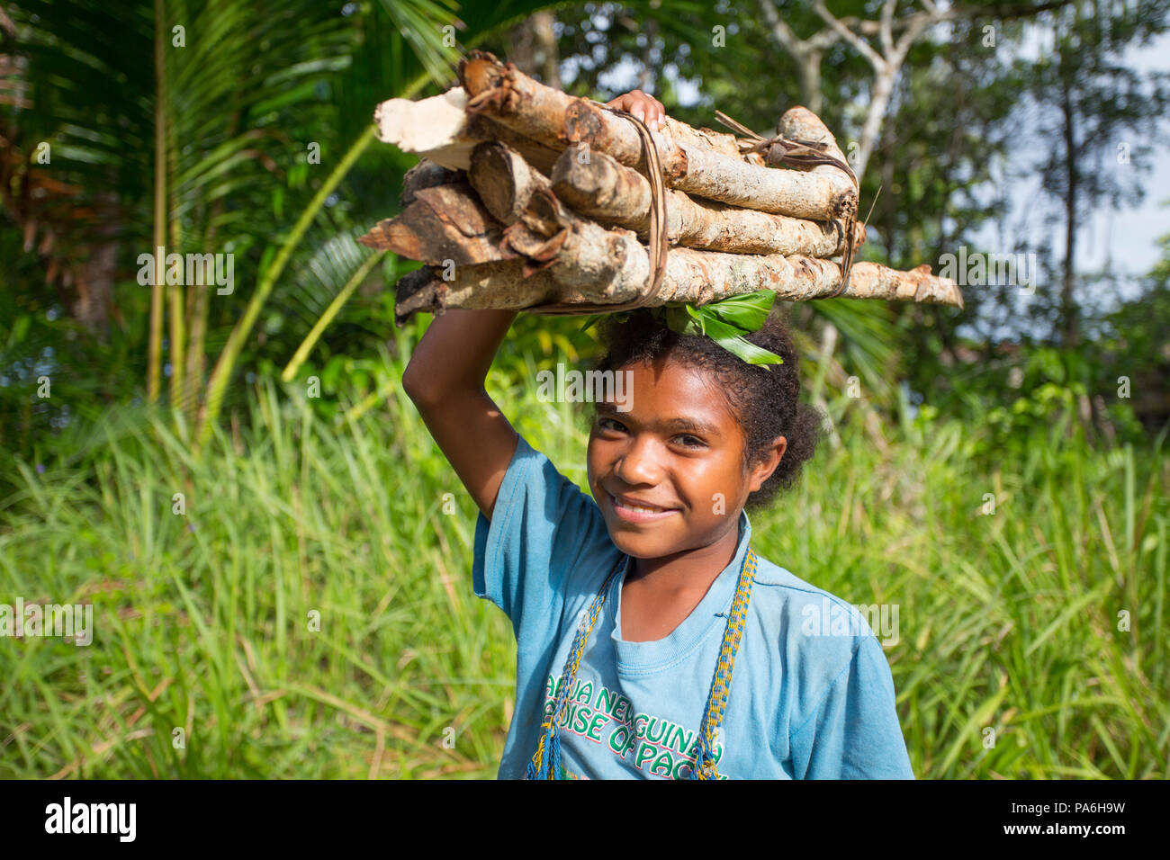 Donne bastoncini di bilanciamento sulla sua testa - Papua Nuova Guinea Foto Stock