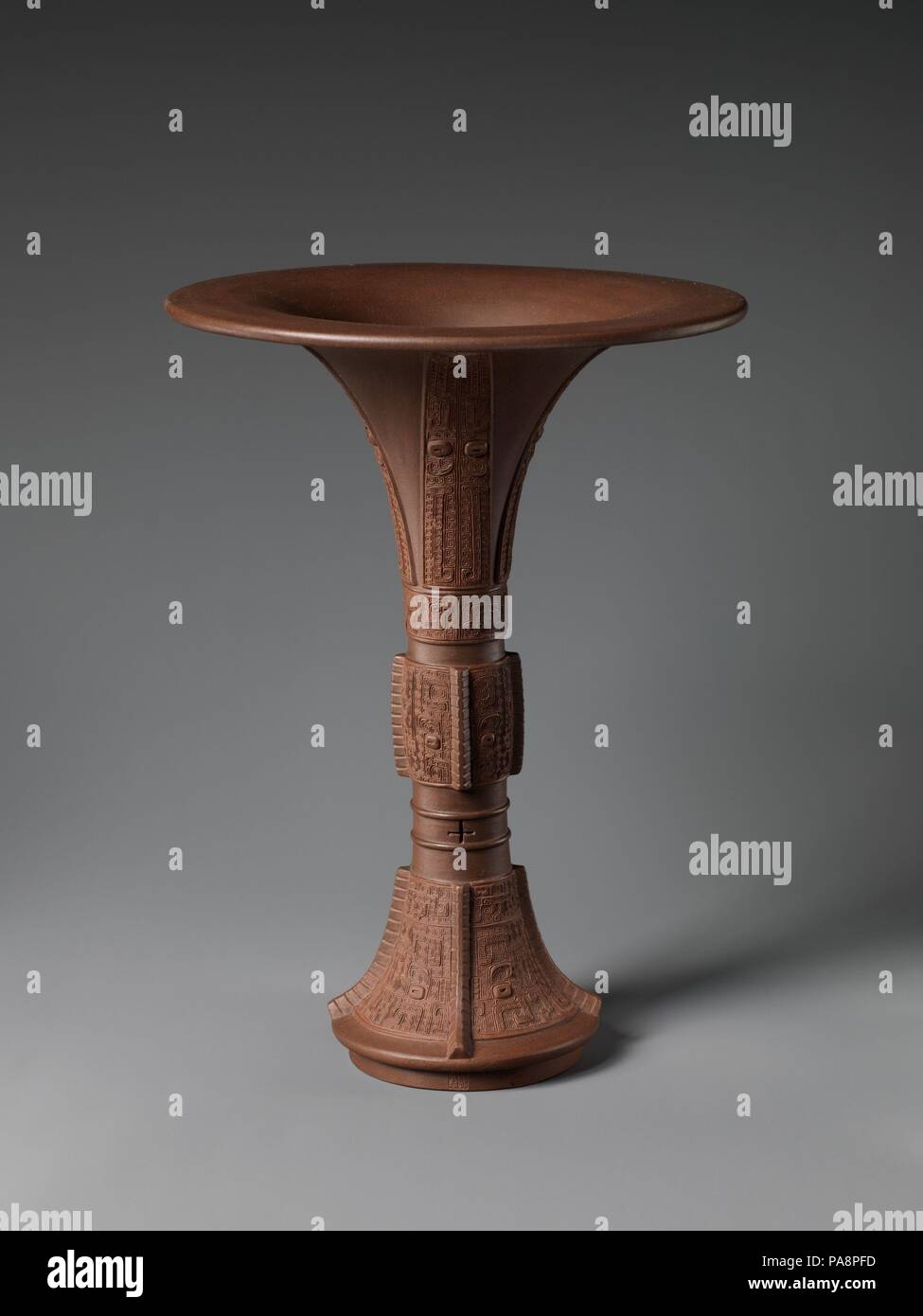 Vaso in forma di un arcaico vaso di bronzo (GU). Artista: Chen Jinhou (Cinese, attivo del XVIII secolo). Cultura: la Cina. Dimensioni: H. 10 1/8 in. (25,7 cm). Data: XVIII secolo. Sia per la forma e la decorazione della base derivano da navi di prodotto per la prima volta in Cina durante la Shang (ca. 1600 - 1046 A.C. e Zhou (1046 - 256 a.C.) dinastie. A differenza dei pezzi di porcellana prodotta a Jingdezhen, opera realizzata in forni Yixing erano spesso firmato, in questo caso da Chen Jinhou, rendendo questa tradizione ceramica il primo esempio di studio ceramica in global storia della ceramica. Museo: Metropolitan Museum of Art di New Foto Stock