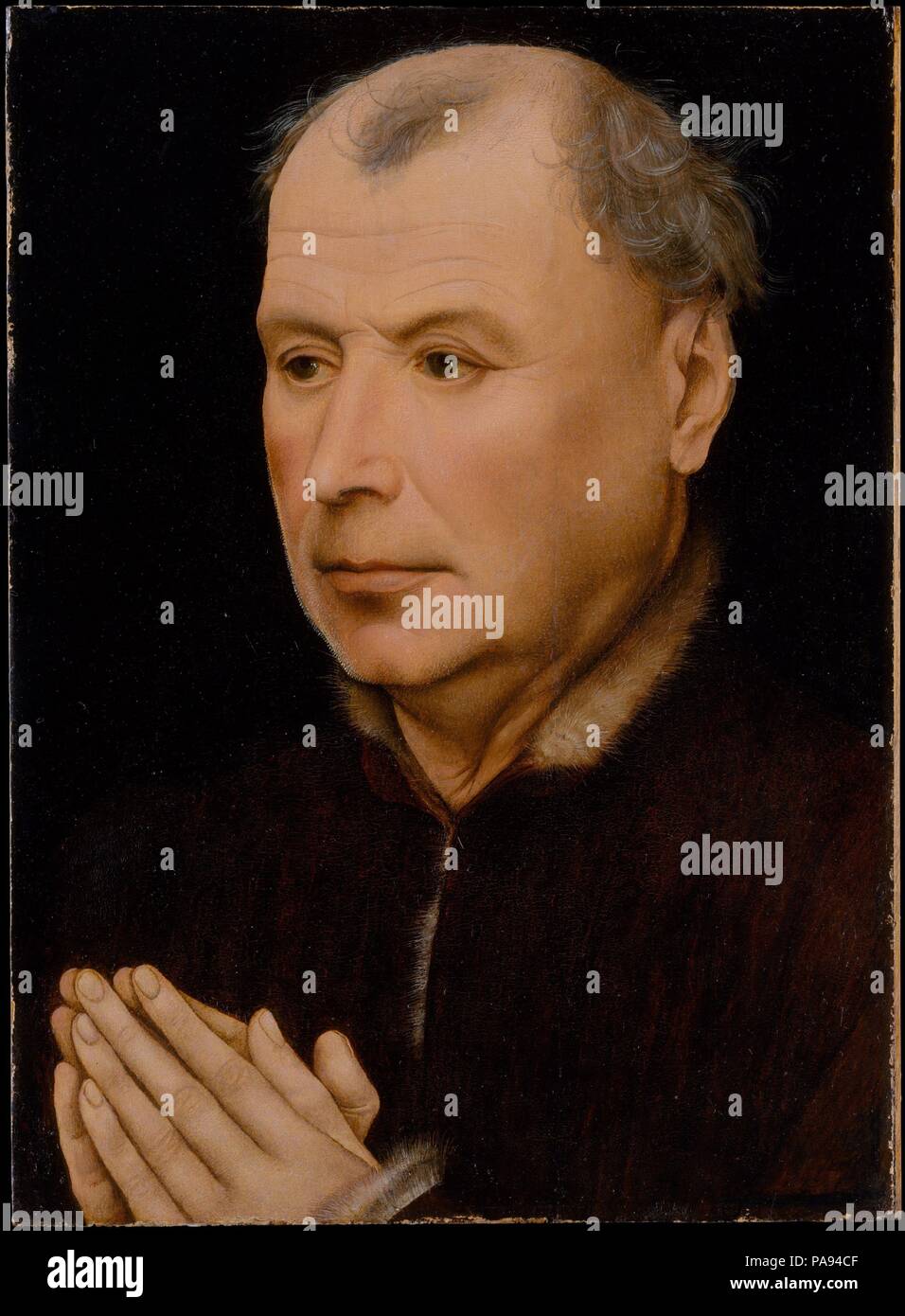 Uomo di preghiera. Artista: laboratorio di Robert Campin (Netherlandish, ca. 1375-1444 Tournai). Dimensioni: complessivamente 12 1/2 x 9 1/8 in. (31,8 x 23,2 cm); superficie dipinta 12 1/2 x 9 in. (31,8 x 23 cm). Data: ca. 1430-35. Questo sitter unisce le sue mani in preghiera, di contemplare ciò che deve essere stata una immagine devozionale su di un pannello adiacente, oggi mancante. La rappresentazione delle funzioni è molto sensibile, particolarmente il rendering delle sfumature della bocca, l'età linee del fronte e le stoppie bianco visibile lungo il contorno della guancia sinistra. Il ritratto è stilisticamente simile a opere di entrambi Robert Camp Foto Stock