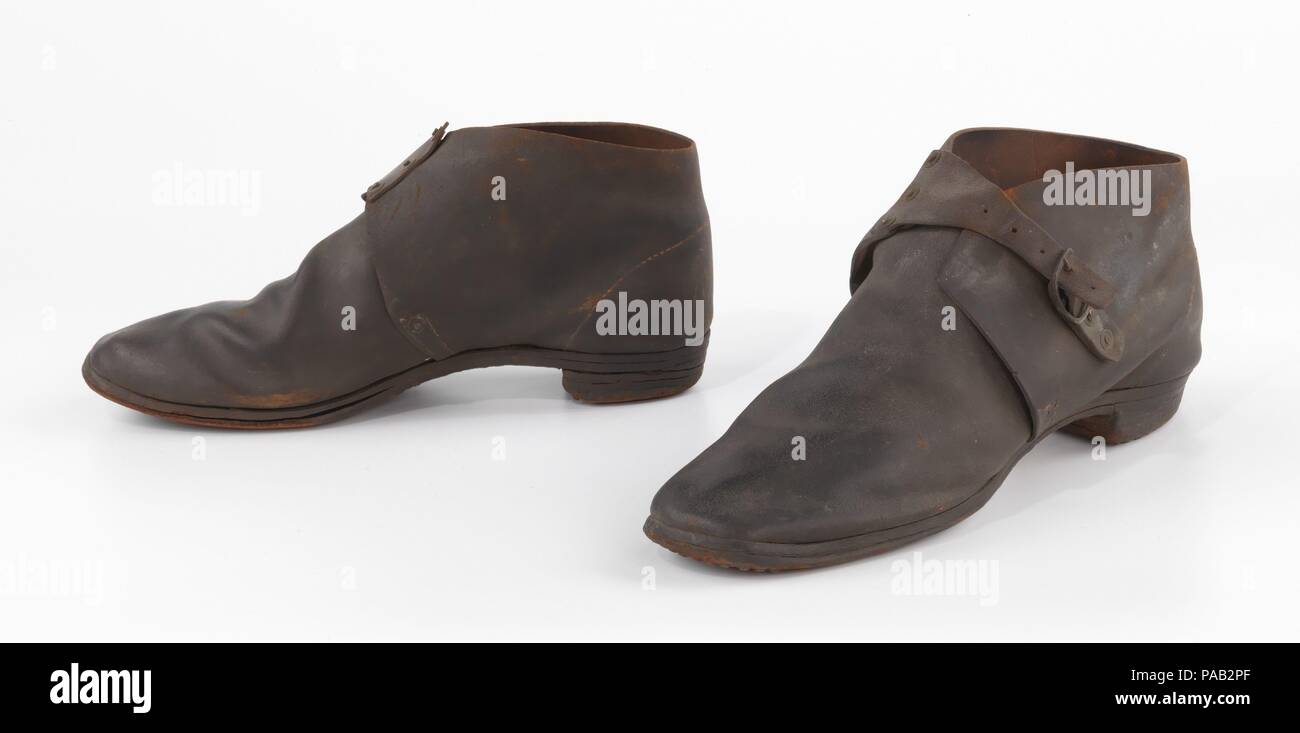 Brogans. Cultura: American. Data: 1860-65. Dall'ultimo quarto del XVIII secolo, la lavorazione della calzatura è stata una grande industria di cottage in Nuova Inghilterra e da circa 1850, una rapida alluvione del neo-inventare macchine specializzate servita a concentrare la produzione negli stabilimenti. La domanda militare per grandi quantitativi di economici e rapidamente le merci prodotte durante la Guerra Civile Americana catalizzato l'espansione della produzione industriale. Questo primo esempio di una fabbrica fatta prodotte in massa a coppia di brogans incorpora diversi nuovi processi industriali: macchina di cucitura a punto a catenella, rivettata di cinghie, e mechanicall Foto Stock