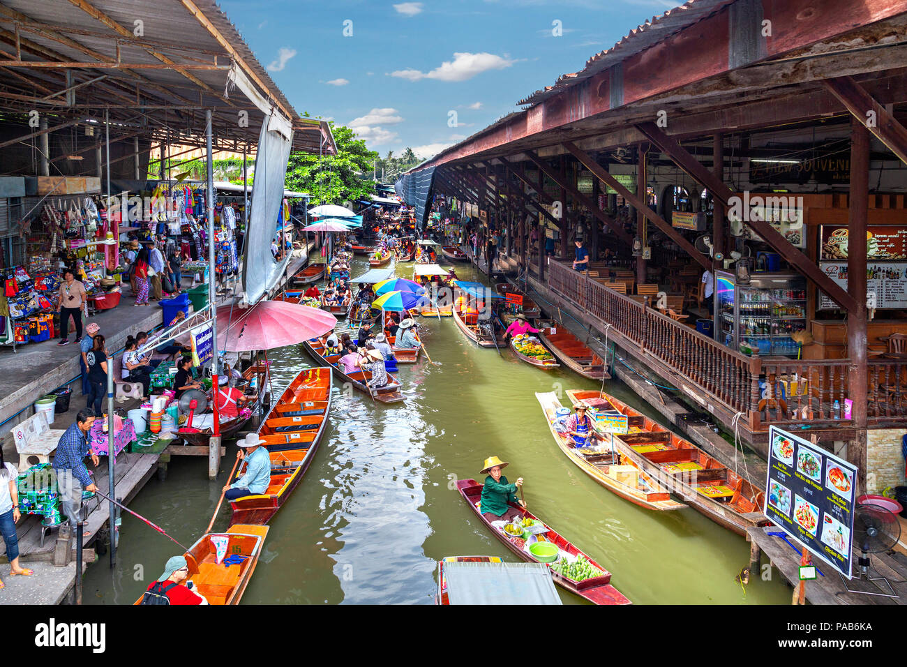 Mercato galleggiante con frutta e verdura e diversi articoli venduti da piccole imbarcazioni, in Damnoen Saduak, Thailandia Foto Stock