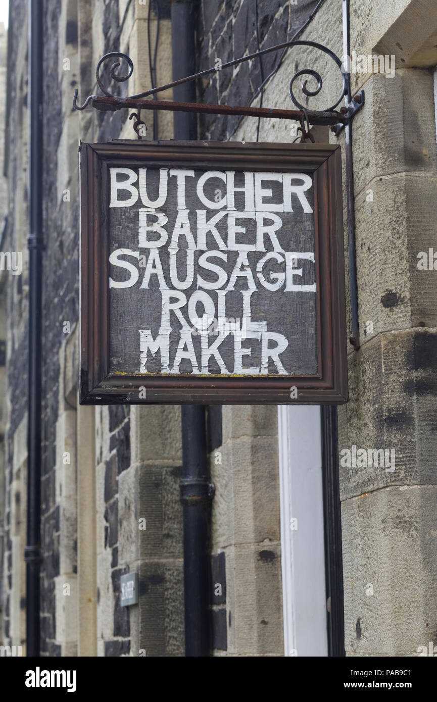 Butcher baker salsiccia rotolo maker vecchio segno arrugginito Foto Stock
