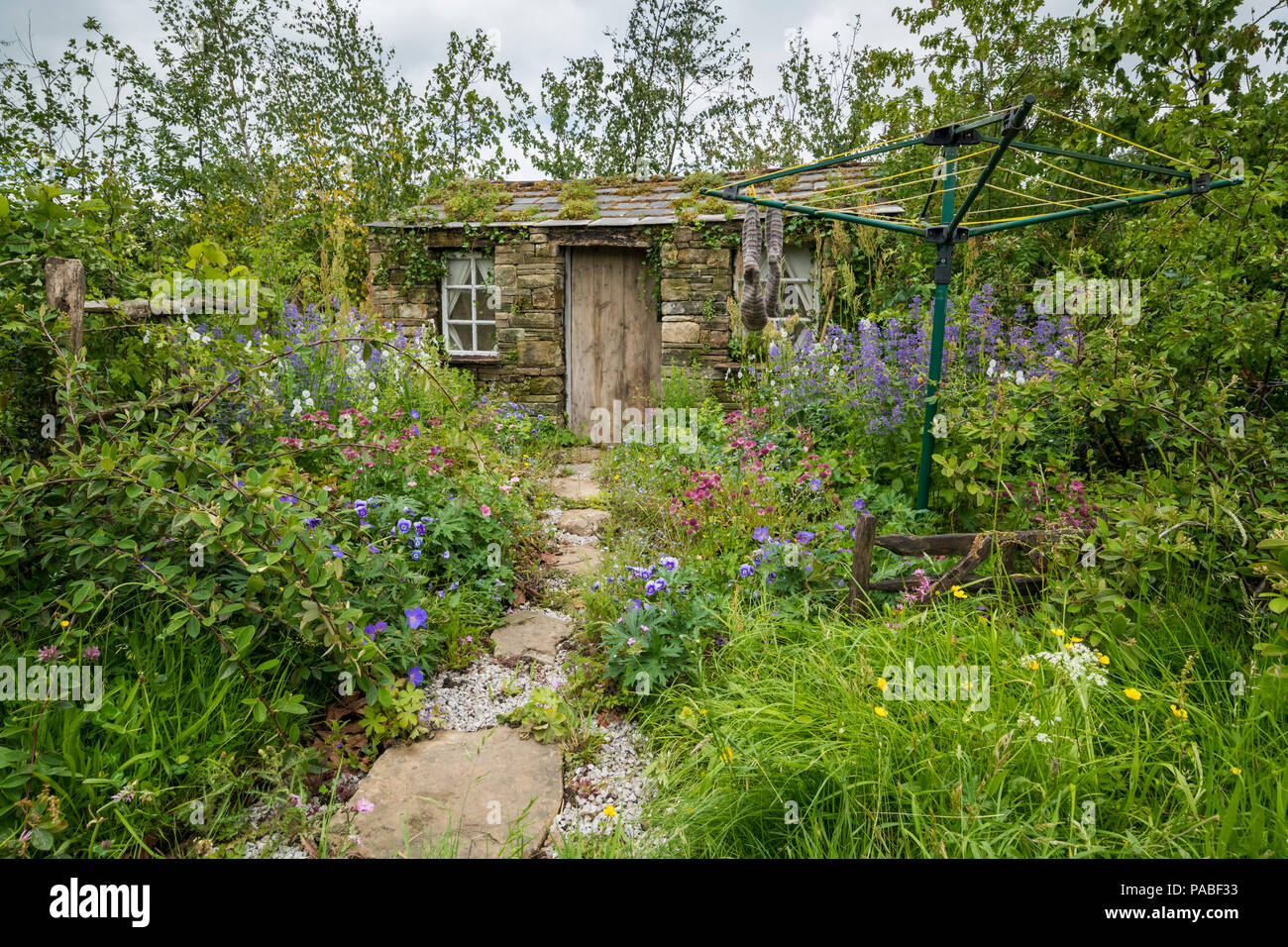 Spettacolo bellissimo giardino (naturale di piantagione e colorati di bordi e rustico barn cottage) - tempo di fieno nei Dales, RHS Chatsworth Flower Show, Inghilterra, Regno Unito. Foto Stock