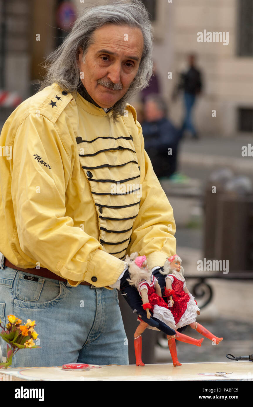 Marcel, un vestito in maniera colorata burattinaio, con i suoi ballerini di Cancan nell'esecuzione in Piazza Navona a Roma Foto Stock