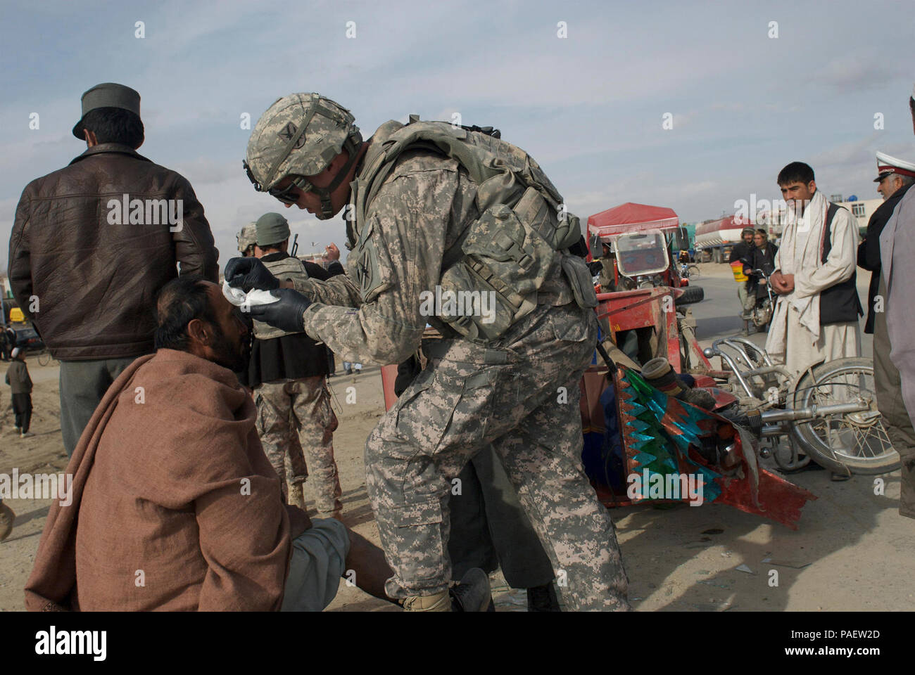 Stati Uniti Pfc dell'esercito. Michael McDonald controlla i segni vitali di un uomo afgano che ha distrutto il suo motociclo su autostrada 1, vicino a inoltrare una base operativa Vulcan nella provincia di Ghazni, Afghanistan, Feb. 24. McDonald, neonato, Ga., nativo, serve come un medic con la Georgia la guardia nazionale del primo plotone, società D, 1° Battaglione, 121 Reggimento di Fanteria, 48th vigili del Team di combattimento. ( Foto Stock