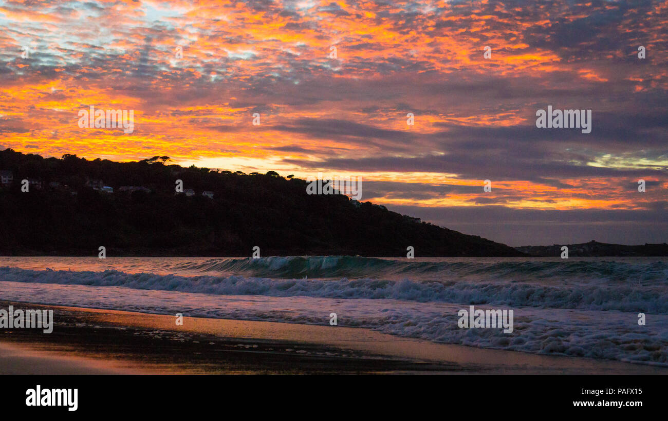 Corbis Bay, inglese tramonto sul mare, serata estiva, cielo incandescente rosa e arancione Foto Stock