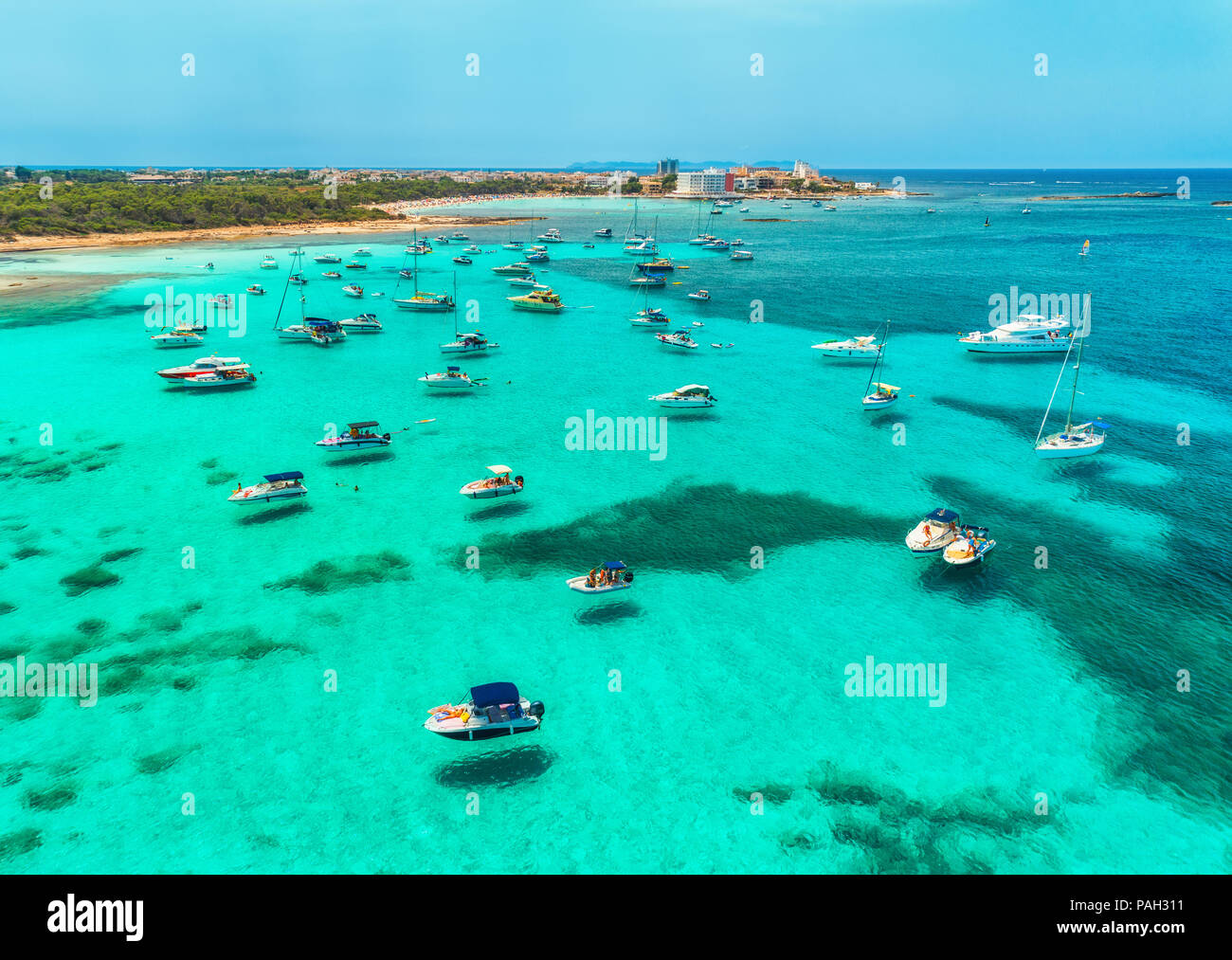 Vista aerea di barche e yacht di lusso e mare trasparente alla giornata di sole a Mallorca, Spagna. Colorato paesaggio estivo con marina bay, acqua azzurra, Sandy Foto Stock
