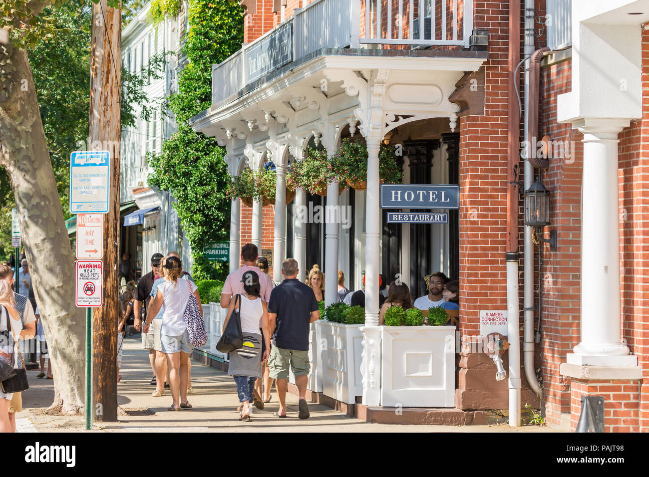 Gruppi di persone a camminare sul marciapiede di fronte all'American Hotel in Sag Harbor, NY Foto Stock