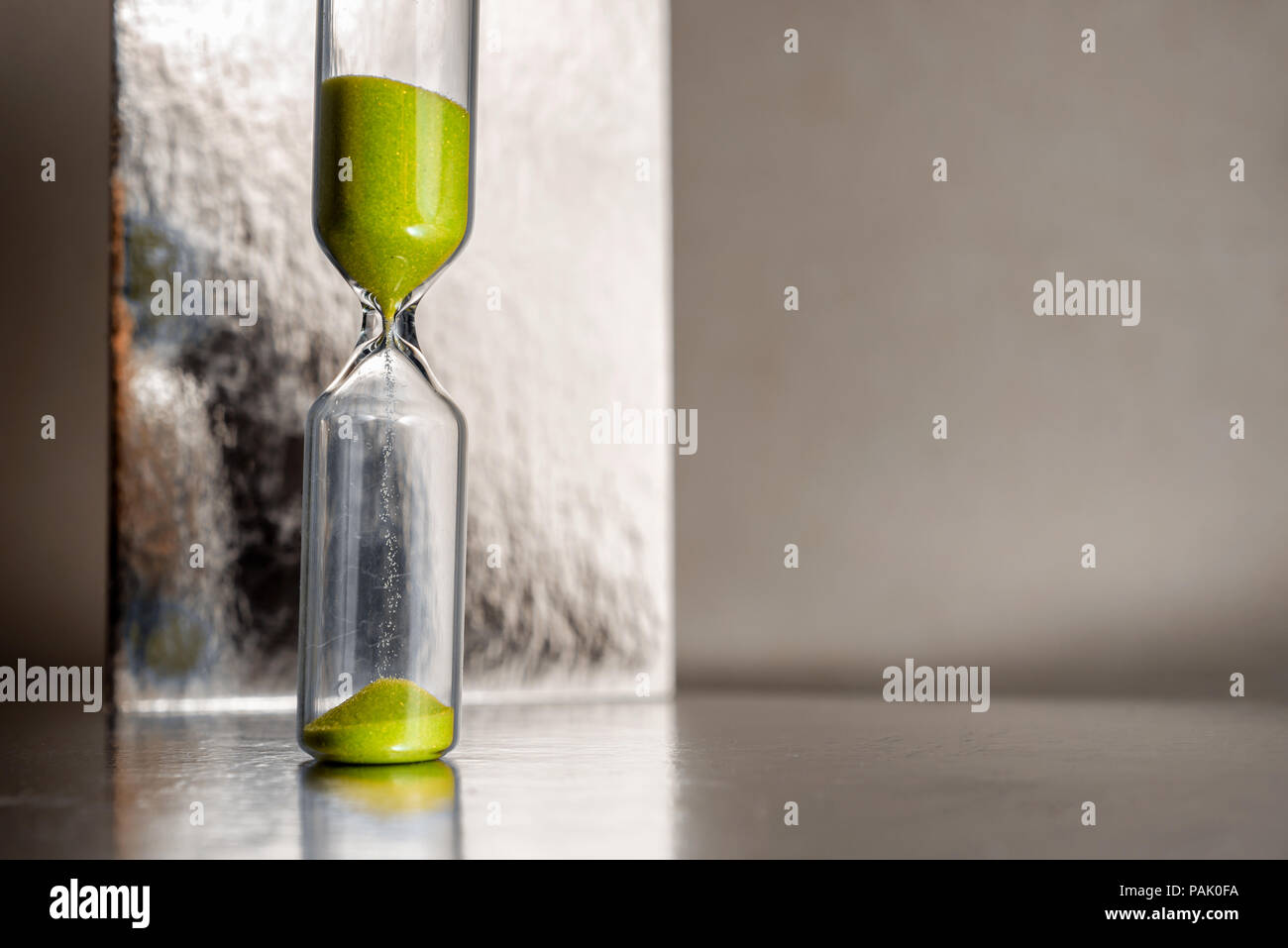 Moderno giallo bellissima clessidra con sfondo luminoso per una copia dello spazio. Tempo di clessidra passando per il concetto di business scadenza, urgenza e in esecuzione fuori del tempo. Foto Stock