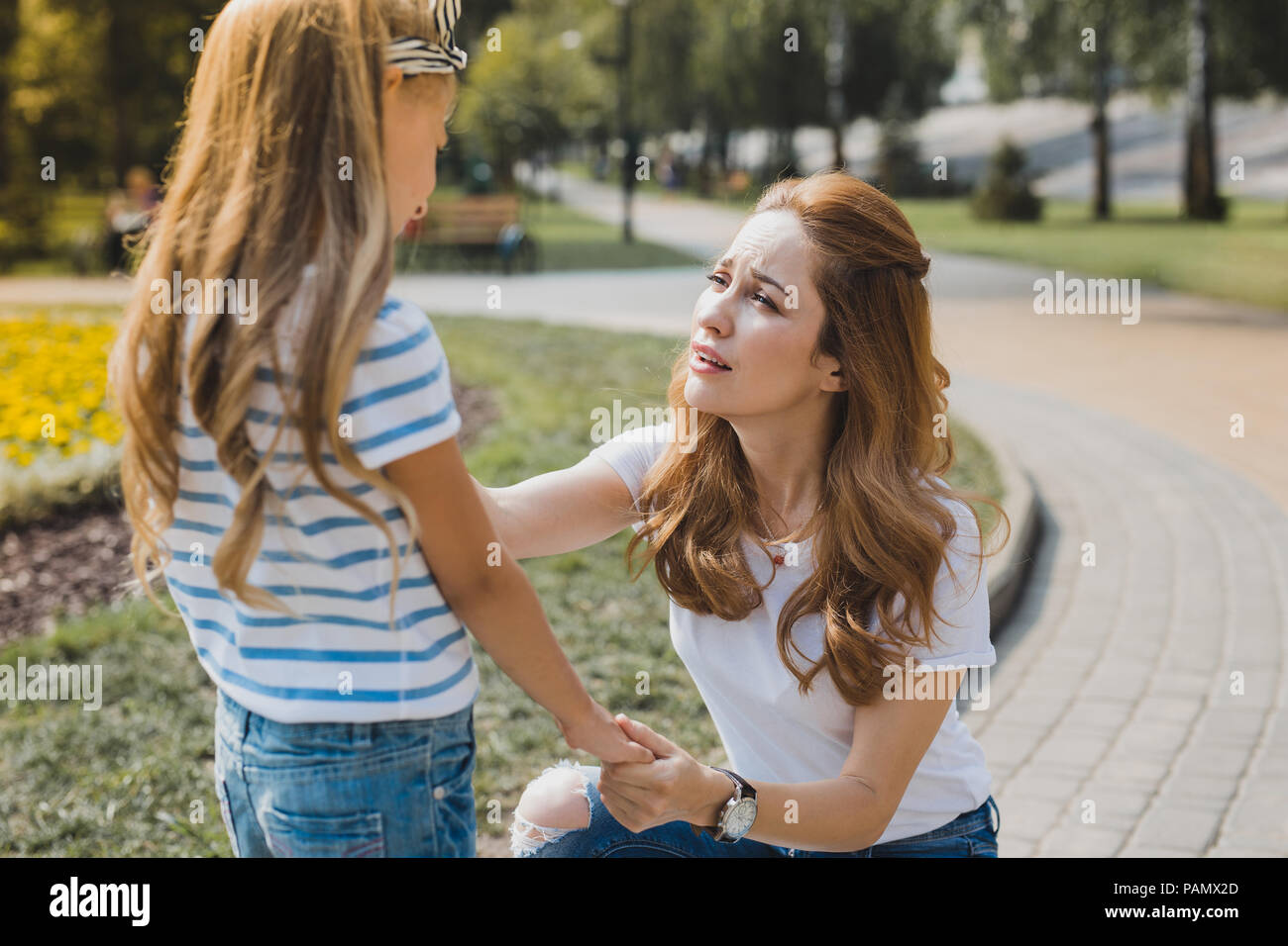 Madre bella sensazione preoccupato tenendo la figlia a scuola Foto Stock