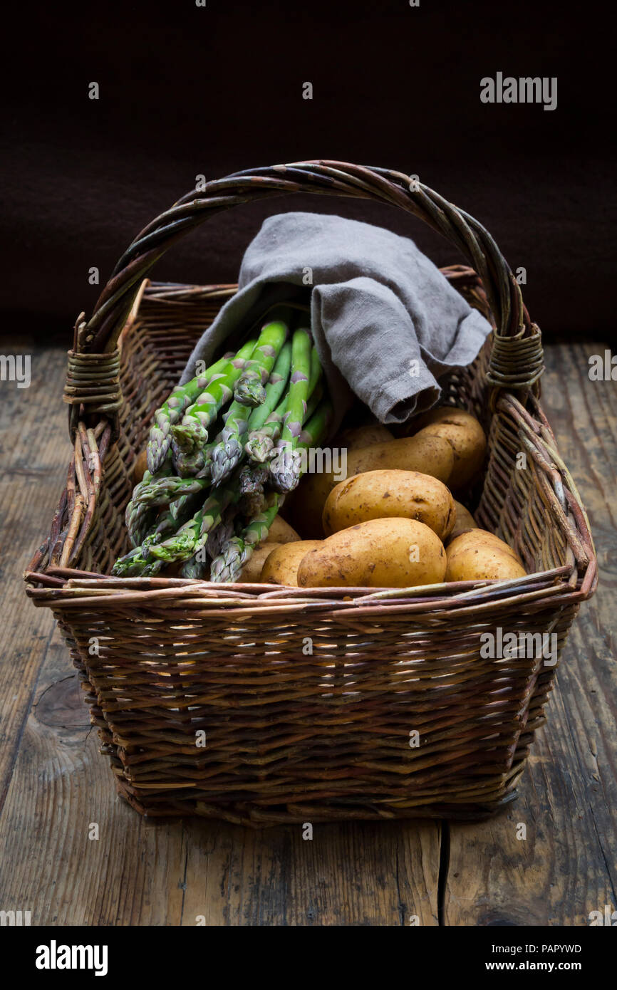 Verde biologico asparagi e patate organico in wiccurbasket Foto Stock