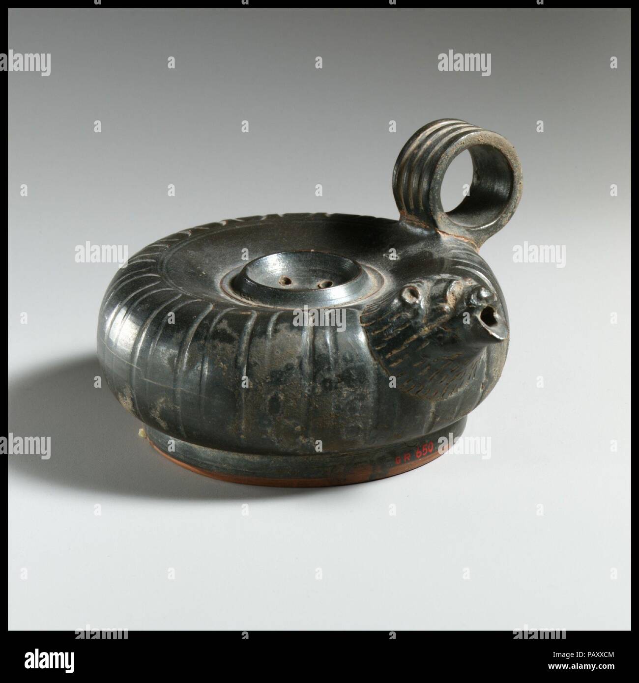 La terracotta guttus (pallone con manico e beccuccio). Cultura: greco, Sud italiano, quello campano. Dimensioni: 2 7/8a. (7.3Cm). Data: Del IV secolo A.C. In arte greca, la testa di un leone è la tipica forma di tubo di lancio, se per il waterspouts di un edificio monumentale o la bocca di un piccolo recipiente. Museo: Metropolitan Museum of Art di New York, Stati Uniti d'America. Foto Stock