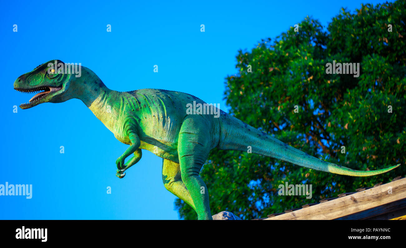 Modello di Velociraptor ruggito contro il cielo blu Foto Stock
