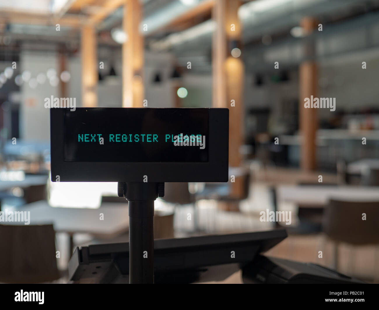 Registratore di cassa in ariose eatery visualizzando accanto Registrati Accedi Foto Stock