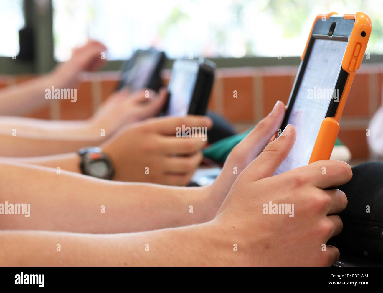 Alta scuola gli studenti che lavorano su utilizzando un ipad tablet stile elettronico del dispositivo calcolatore. pedagogia moderna insegnamento e apprendimento in istruzione istruzione Foto Stock